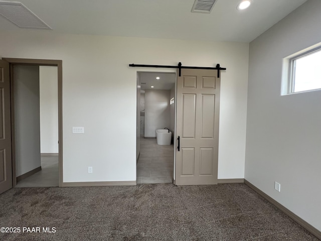 218 Brenna Dr, Chino Valley, AZ 86323 - unfurnished bedroom with carpet, a barn door, baseboards, and recessed lighting