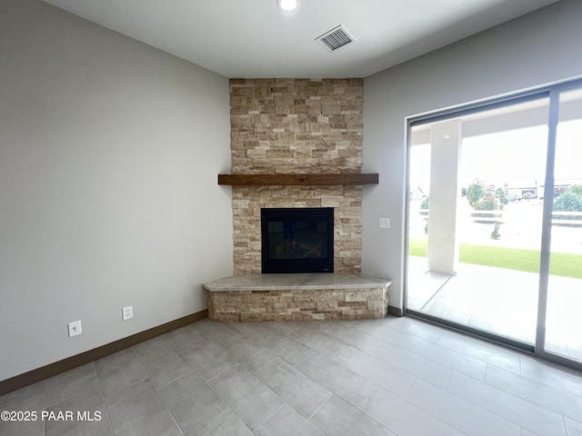 218 Brenna Dr, Chino Valley, AZ 86323 - unfurnished living room featuring healthy amount of natural light, a stone fireplace, baseboards, and tile patterned floors