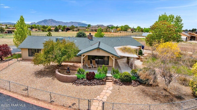 1640 W Grasshopper Ln, Chino Valley, AZ 86323 - view of front of home with a fenced backyard, a mountain view, a porch, and a shingled roof