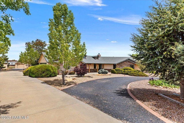 1640 W Grasshopper Ln, Chino Valley, AZ 86323 - view of front of home with stone siding and a chimney