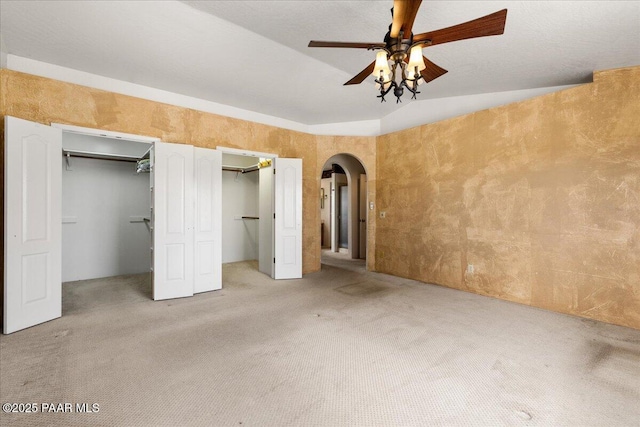 1640 W Grasshopper Ln, Chino Valley, AZ 86323 - unfurnished bedroom featuring arched walkways, carpet flooring, multiple closets, and a ceiling fan