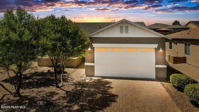 13058 E Acosta St, Dewey-Humboldt, AZ 86327 - view of front facade with decorative driveway, an attached garage, and board and batten siding