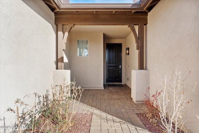 view of exterior entry featuring a patio area