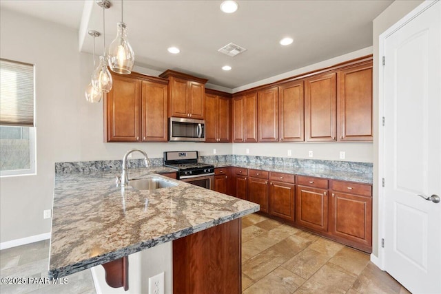 kitchen featuring pendant lighting, sink, a breakfast bar, stainless steel appliances, and kitchen peninsula