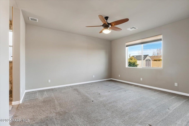 carpeted spare room with ceiling fan