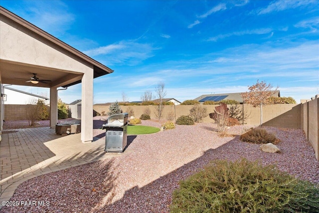 view of yard with ceiling fan and a patio