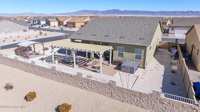 back of house featuring a pergola and a mountain view