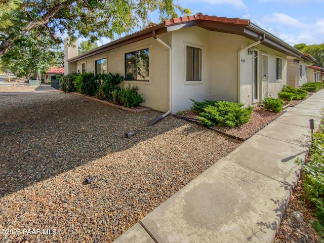410 Apache Plume Trl, Prescott, AZ 86301 - view of side of home with stucco siding and a chimney
