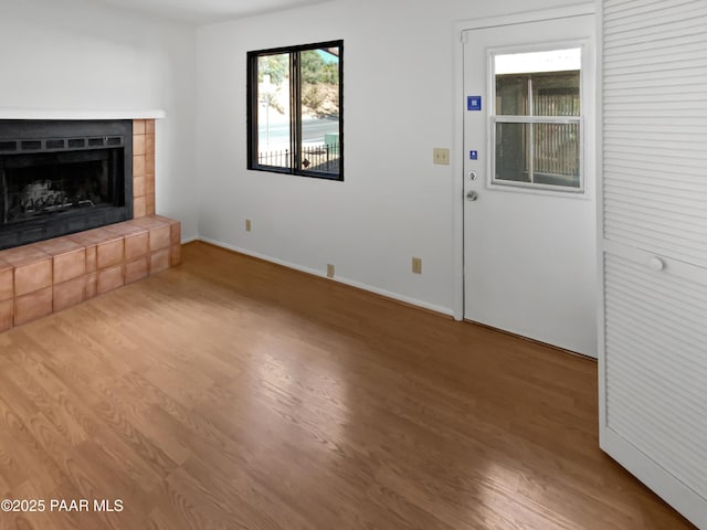 410 Apache Plume Trl, Prescott, AZ 86301 - unfurnished living room with wood finished floors and a tile fireplace