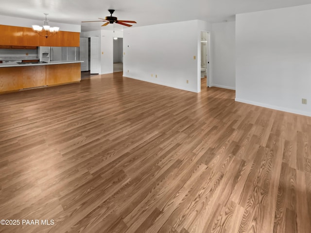 410 Apache Plume Trl, Prescott, AZ 86301 - unfurnished living room with a chandelier, wood finished floors, and a ceiling fan