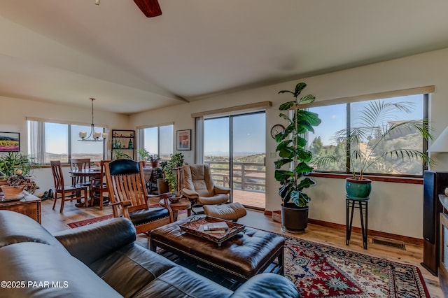930 Ohio St, Prescott, AZ 86303 - living area featuring plenty of natural light, wood finished floors, a chandelier, vaulted ceiling, and ceiling fan