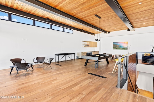 rec room featuring beamed ceiling, wood ceiling, and light hardwood / wood-style flooring