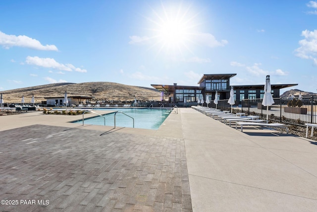 view of swimming pool featuring a mountain view and a patio area