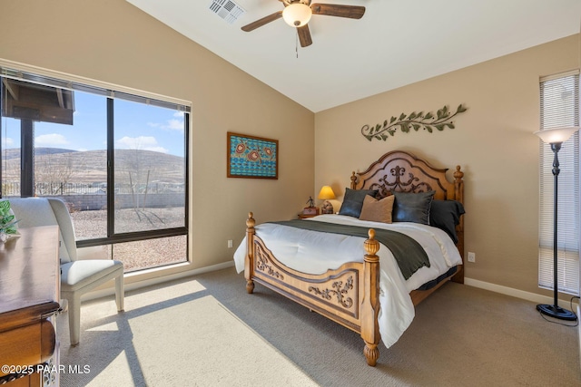 carpeted bedroom with a mountain view, vaulted ceiling, and ceiling fan