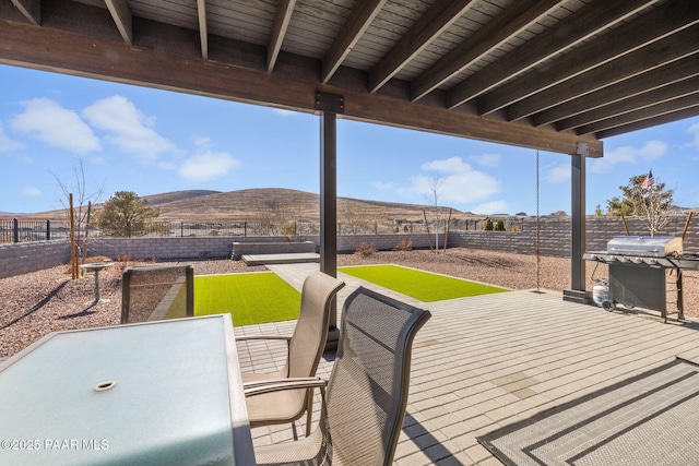 view of patio / terrace featuring a mountain view and a grill