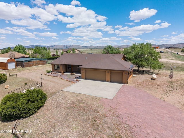 25870 N Merlot Ln, Paulden, AZ 86334 - single story home featuring driveway, an attached garage, covered porch, fence, and a mountain view