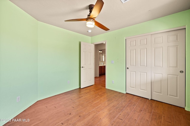 25870 N Merlot Ln, Paulden, AZ 86334 - unfurnished bedroom with light wood-type flooring, a closet, and baseboards