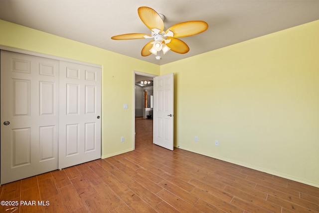 25870 N Merlot Ln, Paulden, AZ 86334 - unfurnished bedroom with a closet, wood finished floors, baseboards, and a ceiling fan