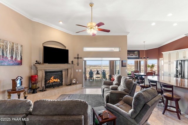 living room featuring light tile patterned flooring, ceiling fan with notable chandelier, ornamental molding, and a premium fireplace