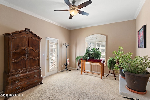 office space featuring baseboards, ceiling fan, ornamental molding, and light colored carpet