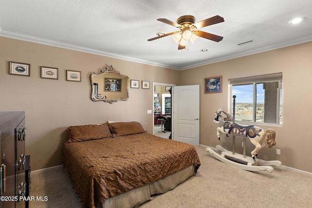 carpeted bedroom featuring a ceiling fan, ornamental molding, baseboards, and visible vents