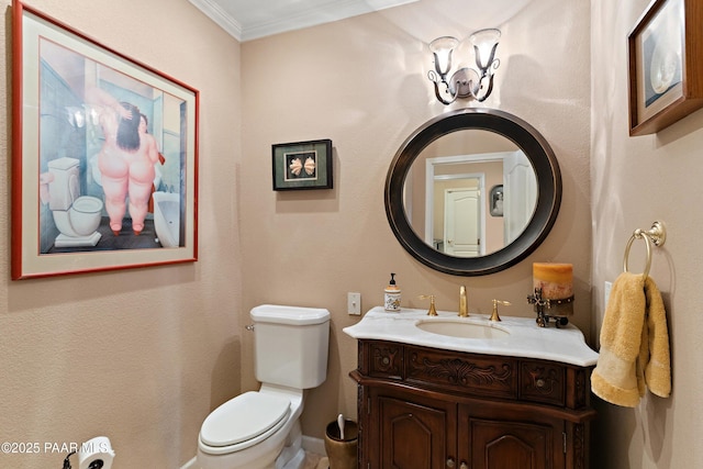 half bathroom featuring crown molding, toilet, and vanity