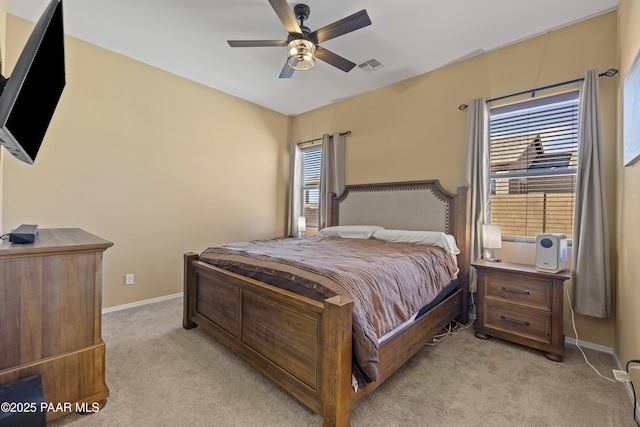 bedroom featuring visible vents, ceiling fan, light colored carpet, and baseboards
