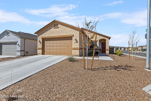 ranch-style home with stucco siding, concrete driveway, and an attached garage