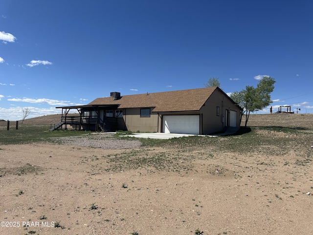 3125 W Big Chino Rd, Paulden, AZ 86334 - back of property with an attached garage, concrete driveway, and stairs