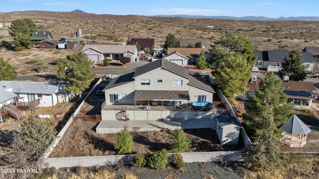 birds eye view of property with a mountain view