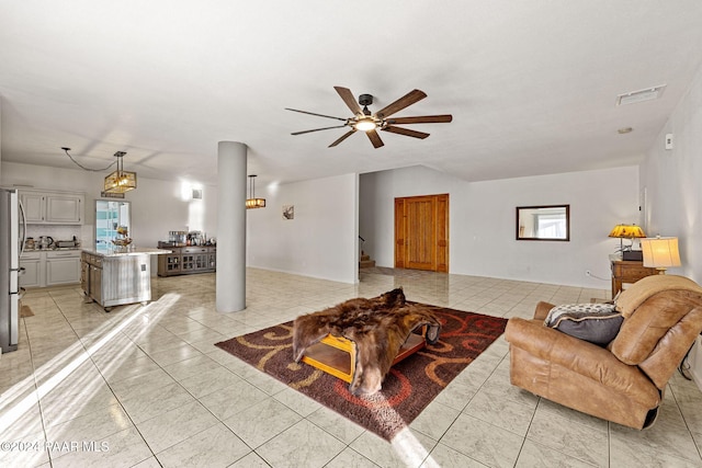 living room with ceiling fan and light tile patterned flooring