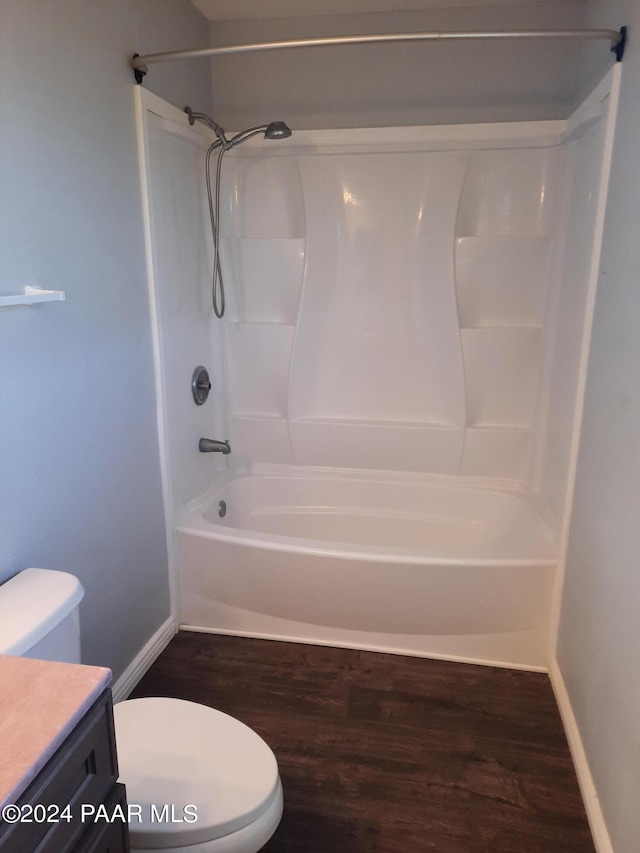 full bathroom with hardwood / wood-style flooring, vanity, toilet, and shower / tub combination