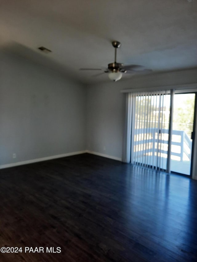 unfurnished room with dark hardwood / wood-style floors and ceiling fan