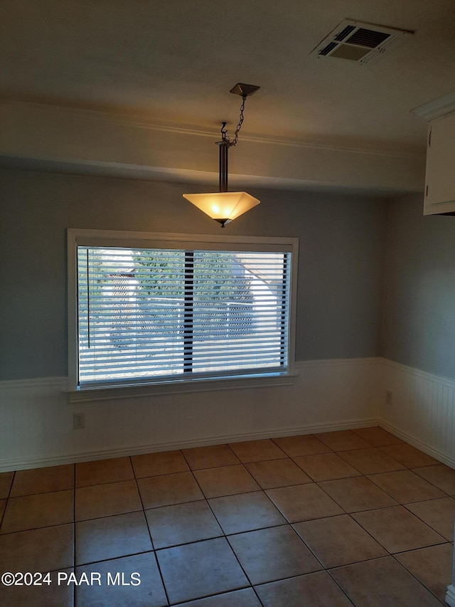 unfurnished room with a healthy amount of sunlight and light tile patterned floors