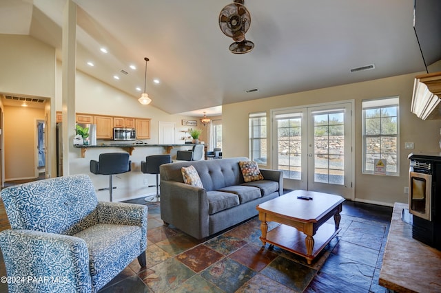 living room with french doors and high vaulted ceiling