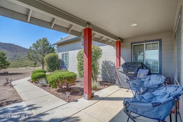 view of patio / terrace featuring a mountain view and grilling area