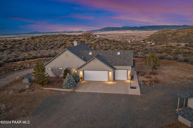 view of front facade featuring a mountain view and a garage