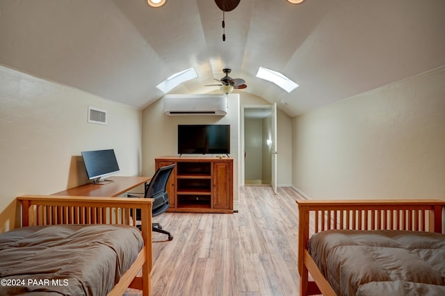 bedroom featuring ceiling fan, light hardwood / wood-style flooring, and vaulted ceiling with skylight