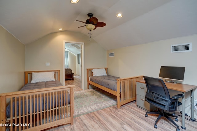 bedroom featuring ceiling fan, lofted ceiling, and light hardwood / wood-style flooring