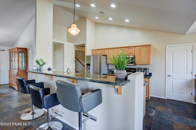 kitchen featuring high vaulted ceiling, hanging light fixtures, dark stone countertops, kitchen peninsula, and stainless steel appliances