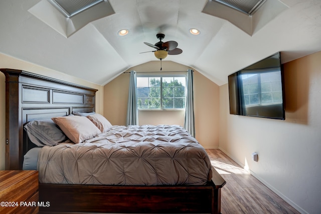 bedroom with ceiling fan, wood-type flooring, and lofted ceiling