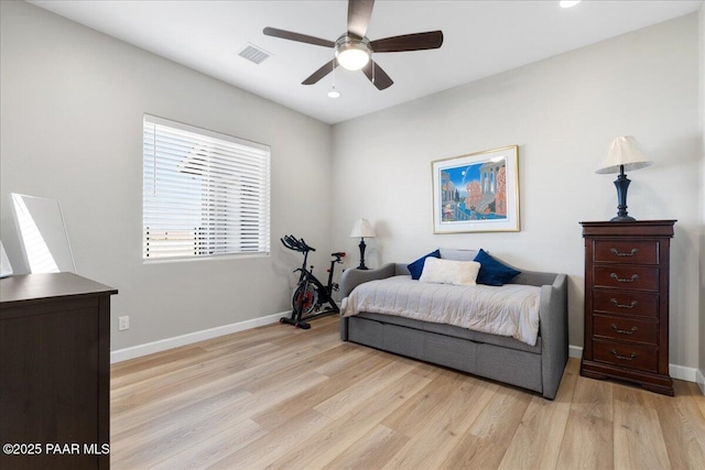 bedroom featuring light wood-style flooring, visible vents, and baseboards