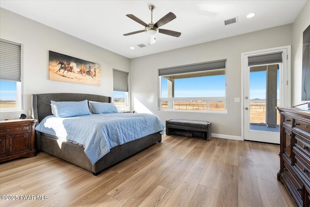 bedroom with access to outside, visible vents, light wood-style flooring, and recessed lighting