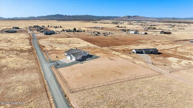 drone / aerial view with a desert view, a rural view, and a mountain view