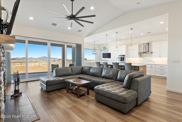 living area with recessed lighting, visible vents, and light wood-style flooring