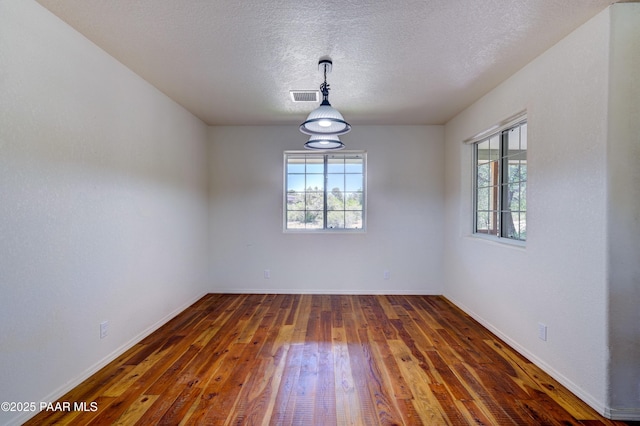 2785 W Bard Ranch Rd, Prescott, AZ 86305 - unfurnished room featuring plenty of natural light, hardwood / wood-style flooring, and a textured ceiling