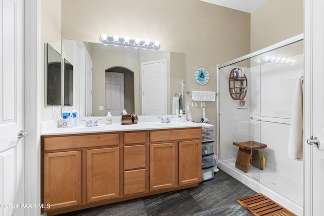 bathroom featuring vanity and a shower with shower door