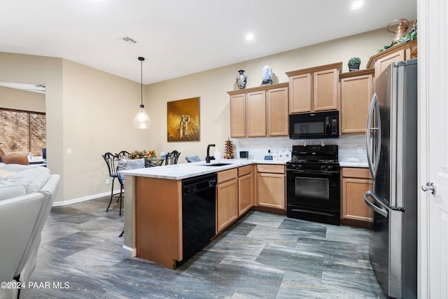 kitchen with kitchen peninsula, backsplash, sink, black appliances, and pendant lighting