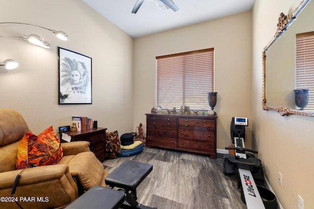 living area with ceiling fan and dark hardwood / wood-style floors