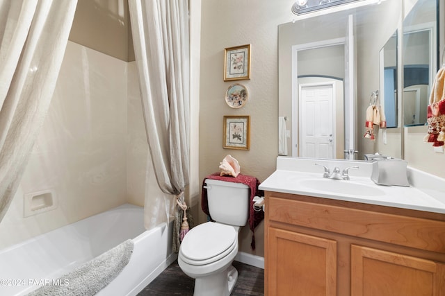 full bathroom featuring shower / bath combo, vanity, and toilet